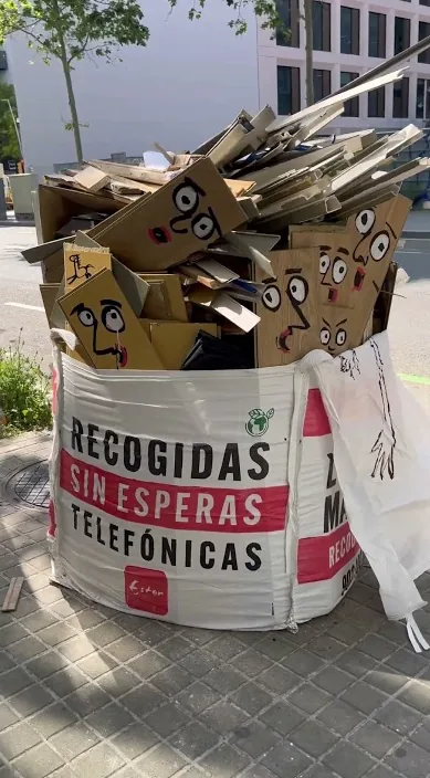 Rubble bag on the street filled with painted cardboard faces, Barcelona, Art Is Trash