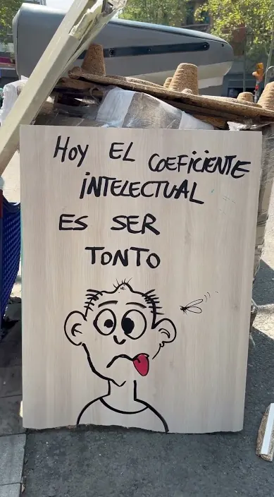 Funny face and IQ line – street art in Barcelona Painted board with a funny face and a line about the intelligence quotient, Barcelona, Art Is Trash