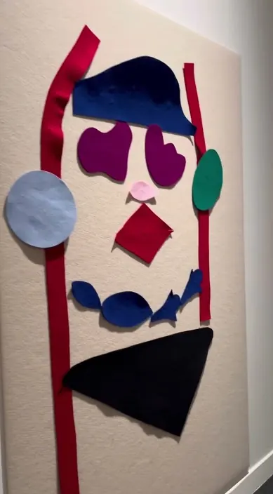 Face made from pieces of fabric – Art Is Trash urban art Face assembled from coloured pieces of fabric on a white board, Barcelona, Art Is Trash