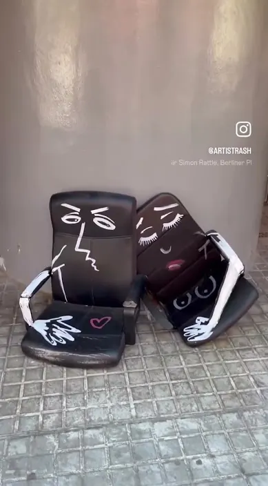 Two painted armchairs – street art in Barcelona Two old armchairs painted with faces on the pavement, Barcelona, Art Is Trash