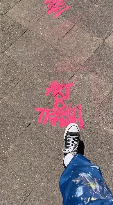 Pink spray on the pavement – Art Is Trash in Düsseldorf “Art Is Trash” sprayed in pink on the pavement during an exhibition, Düsseldorf