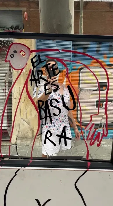 Saying on a shop shutter – Barcelona street art “El arte es basura” painted with figures on a shop shutter, Barcelona, Art Is Trash