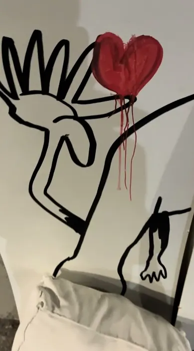 Black line figure with a red heart – Art Is Trash urban art Figure drawn in black lines with a red heart, Barcelona, Art Is Trash