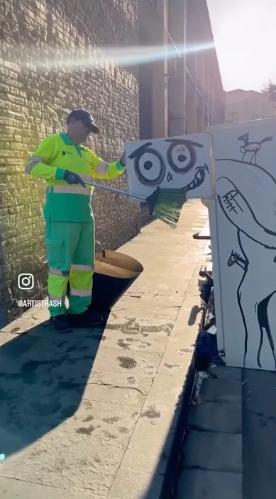 Street cleaner next to a painted cardboard figure lying on the pavement, Barcelona, Art Is Trash